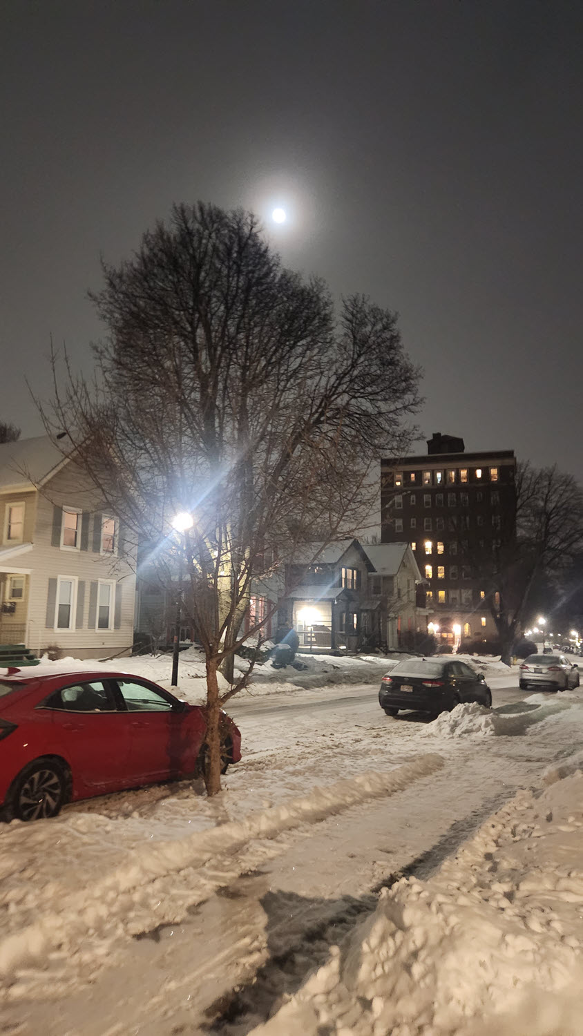 A snowy neighborhood at night