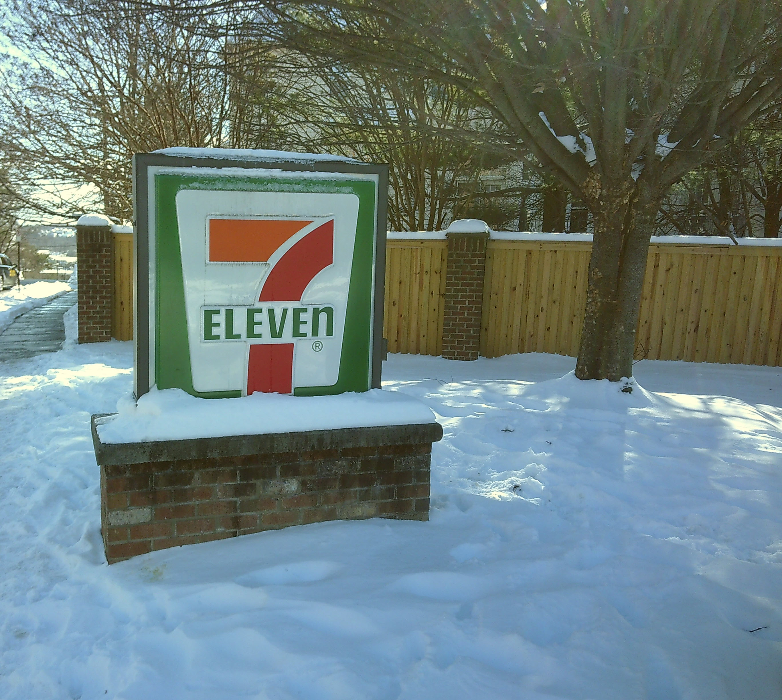 7-11 sign surrounded by and supporting snow