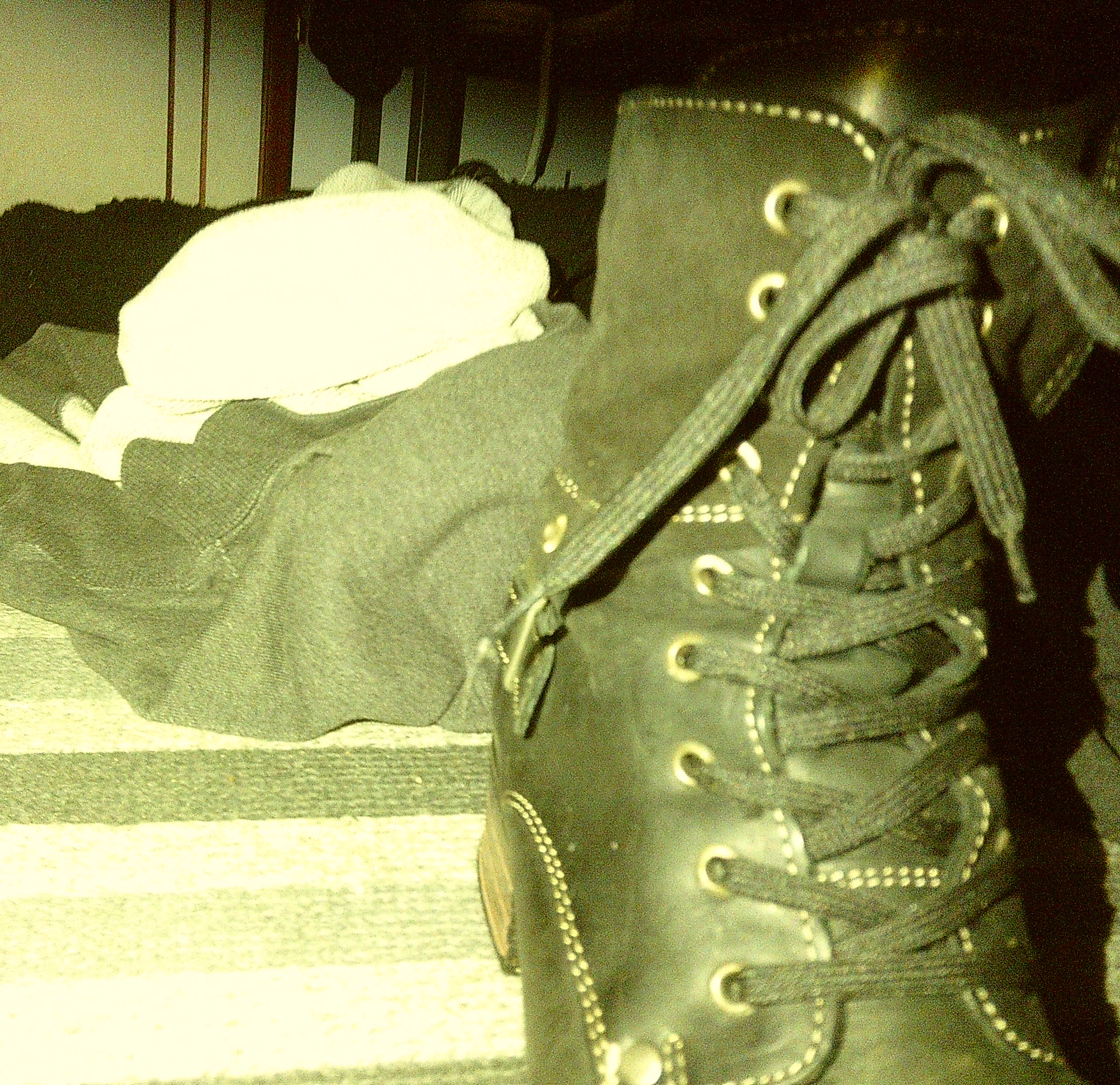 Close up of a boot and hoodies on the floor