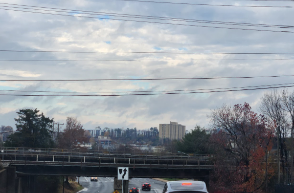 whispy clouds overlooking a rainy suburb