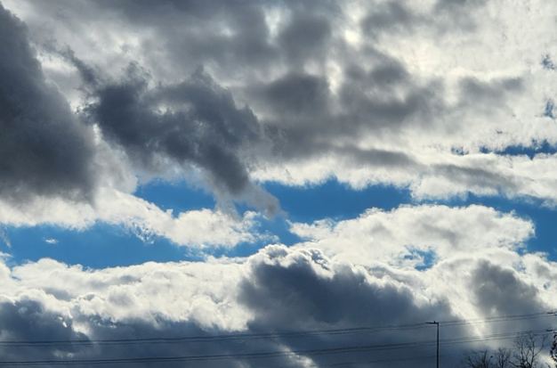 poofy clouds with a streak of blue sky between them