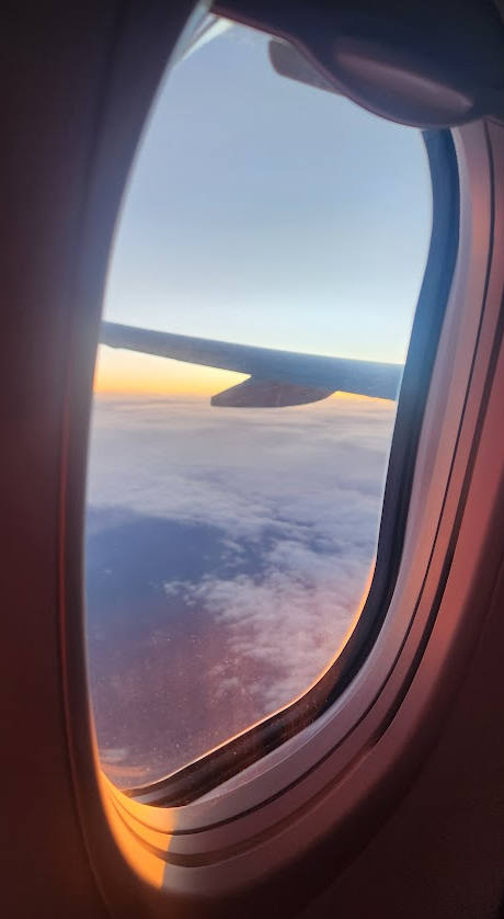 sunset view out of an airplane window at 35,000 feet