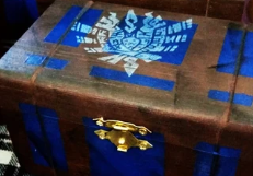 painted replica of the blue Monster Hunter item box with a white Monster Hunter 4U guild logo stamped on top