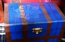 painted replica of the blue Monster Hunter item box with a white Monster Hunter 3U guild logo stamped on top